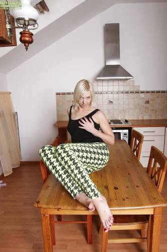 Superb blonde mature Emilia in foot fetish show in the kitchen on nudepicso.com