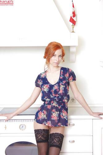Hot czech redhead Daisy Lee in skirt baring her ass and bald pussy in the kitchen - Czech Republic on nudepicso.com