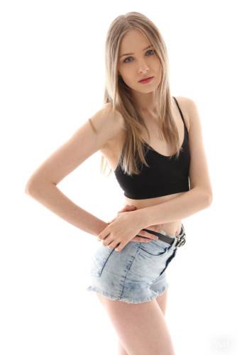 Slender blond teen Nimfa in sexy shorts shows tiny tits and spreads her legs on nudepicso.com