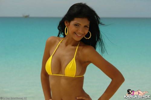 Round Titted Chica Karla Spice In Yellow Bikini Takes Sexy Poses On The Beach on nudepicso.com