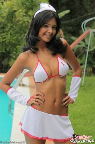Swarthy Latina Karla Spice In White Uniform And Bikini Teasingly Poses By The Pool on nudepicso.com
