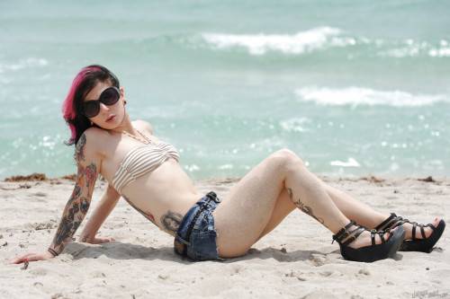 Hot american cutie Joanna Angel uncovering small tits and sexy butt on the beach - Usa on nudepicso.com