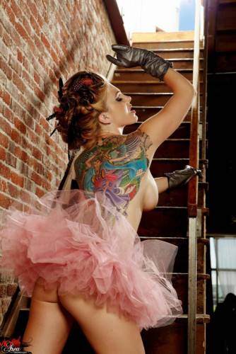Tattooed Redhead With Big Boobs And Long Legs Jesse Capelli Poses On The Stairs on nudepicso.com