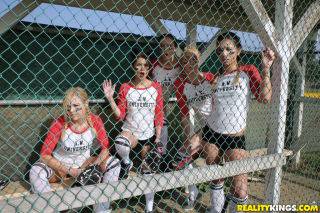 Several busty softball-playing hotties end up strap-on fucking each on nudepicso.com