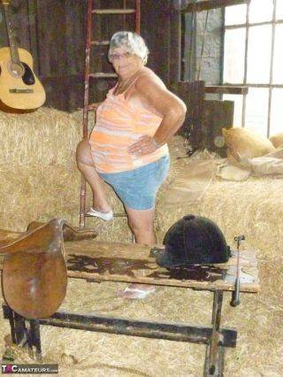 Granny frolics in the hay on nudepicso.com