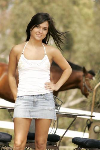 Sexy Brunette Doll Eden Petty In Jeans Skirt Makes A Strip Show By A Farm In The Country on nudepicso.com