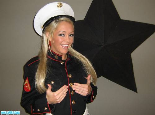 Smiling Tanned Blonde Foxy Jacky In Uniform Shows Her Smoothest Pussy And Round Tits on nudepicso.com