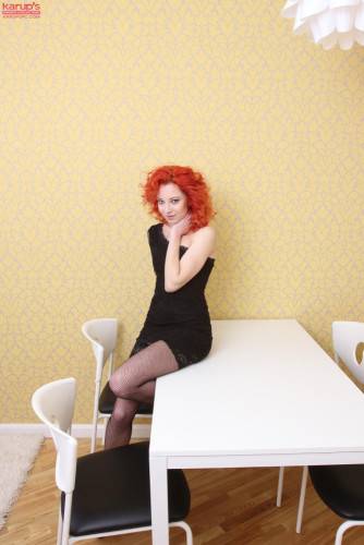 Passionate Redhead Babe In Sexy Black Dress Foxy Zee Shows Her Slit On The Table on nudepicso.com