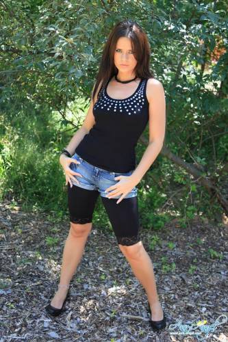 Alluring Brunette Ann Angel In Ultra Stylish Black Denim Shorts Poses In Nature on nudepicso.com