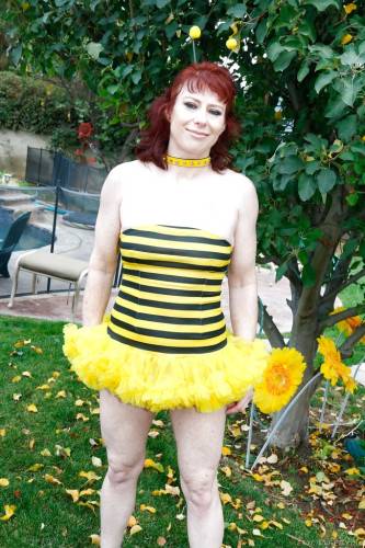 Hot red-haired mature Dirty Garden Girl in fancy skirt exhibiting her ass and jerking off outside on nudepicso.com