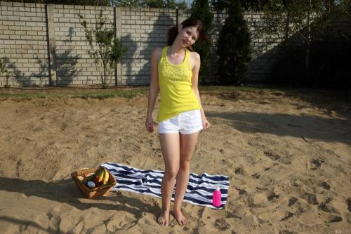 Licentious Brunette Judy Smile Is Stripping Nude On The Beach And Feeding Nub With Banana on nudepicso.com