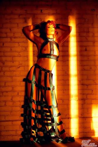 Redhead Justine Joli In Amazing Dress Made Of Leather Belts Poses In The Empty Room on nudepicso.com